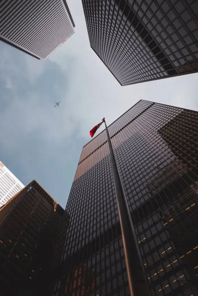 Low angle of modern skyscrapers with a flag.